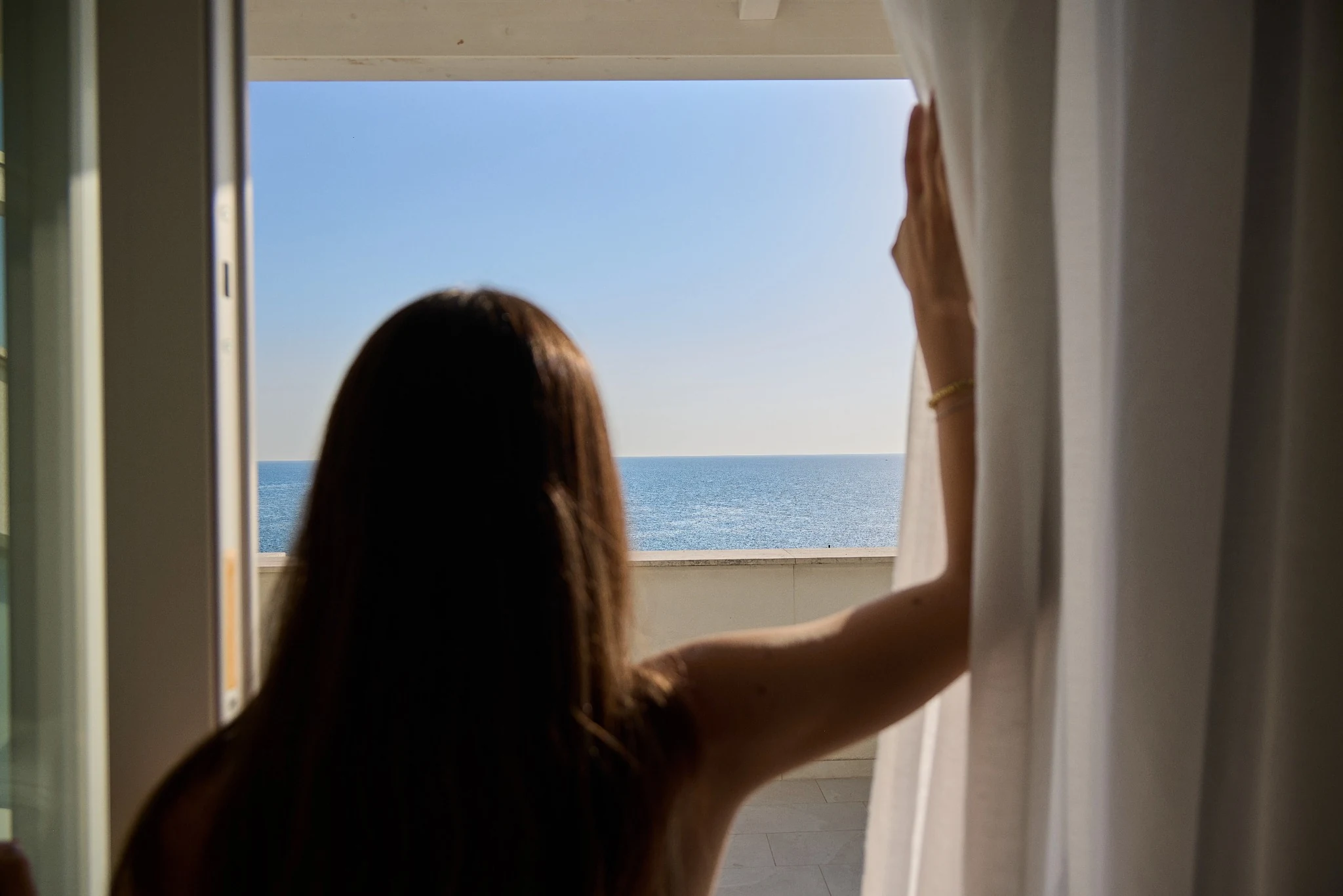 Guest at the window overlooking the Adriatic
